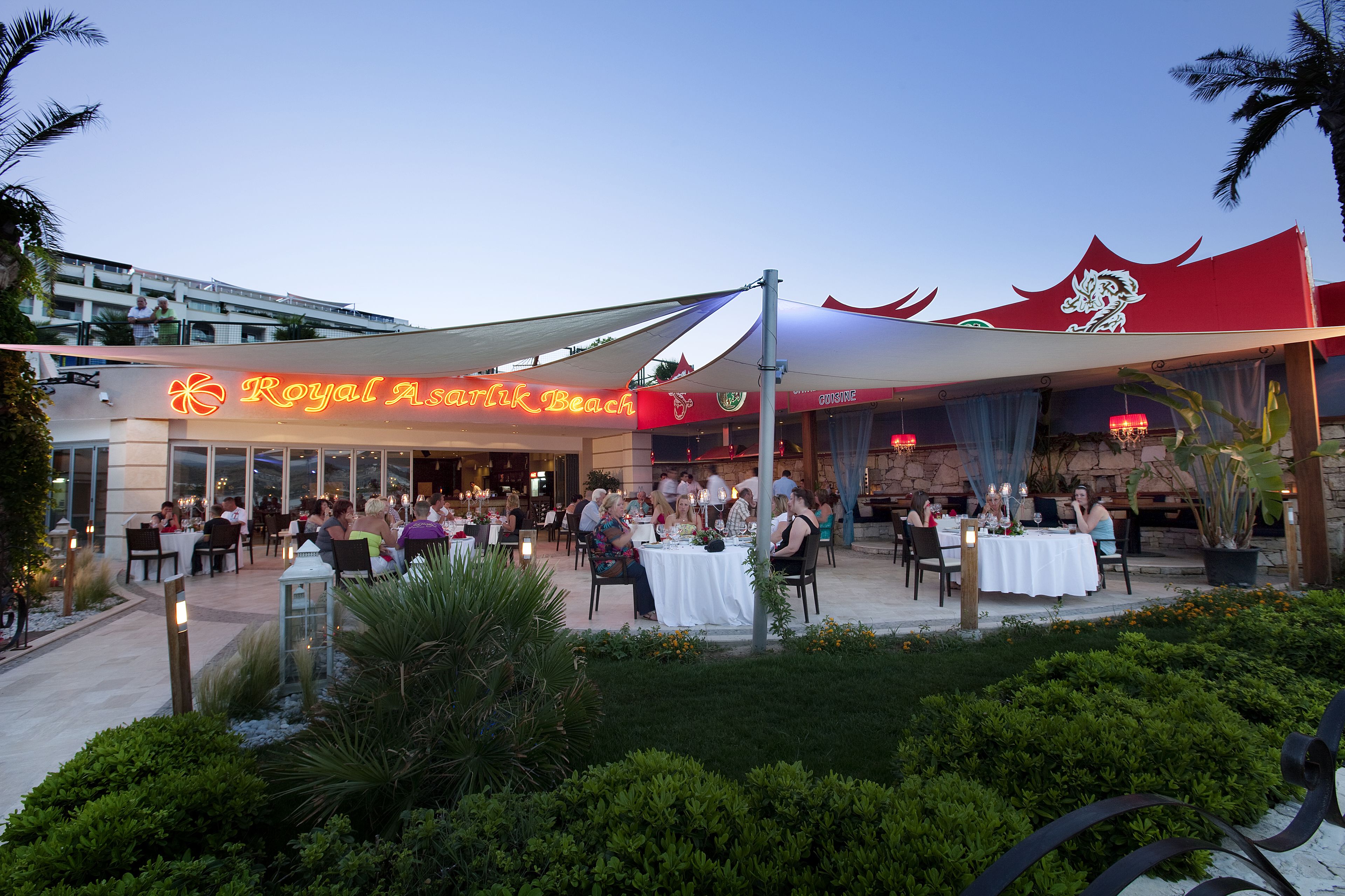 A restaurant named 'Royal Asian Beach' with outdoor seating and a covered patio area.
