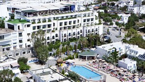 A hotel with multiple balconies, a swimming pool, and outdoor seating areas. - Royal Asarlik Beach Hotel & Spa - All Inclusive (Bodrum)