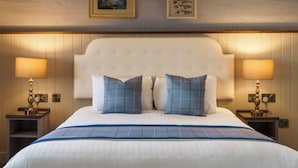 A hotel room with a large bed, two bedside tables with lamps, a headboard with buttons, and framed pictures on the wall. - The Wordsworth, Grasmere- The Inn Collection Group (Ambleside)