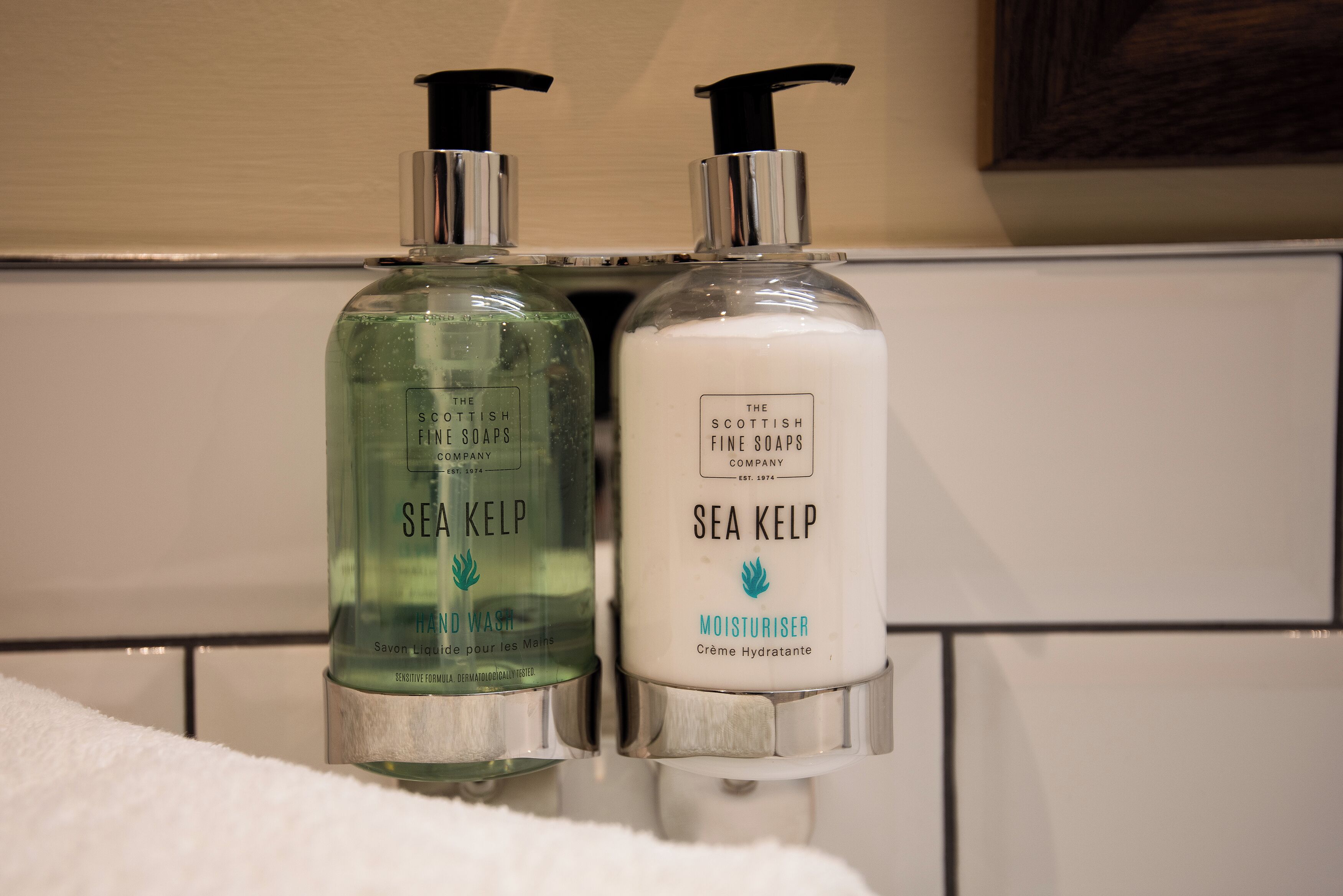 Two bottles of Sea Kelp hand wash and moisturizer on a bathroom counter.