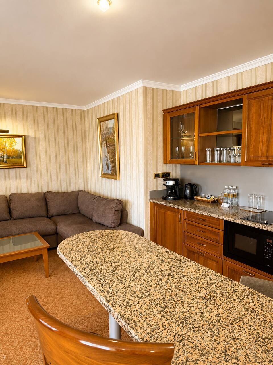 Un espacio habitable compacto con área de cocina, una mesa de comedor y un sofá.