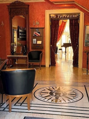 A lobby with a grand mirror, a clock, and a door labeled 'La Terrazza.' - Hotel Otrada (Odesa)