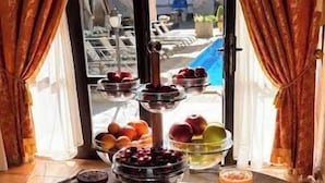 A buffet table with various food items and a fruit display. - Hotel Otrada (Odesa)