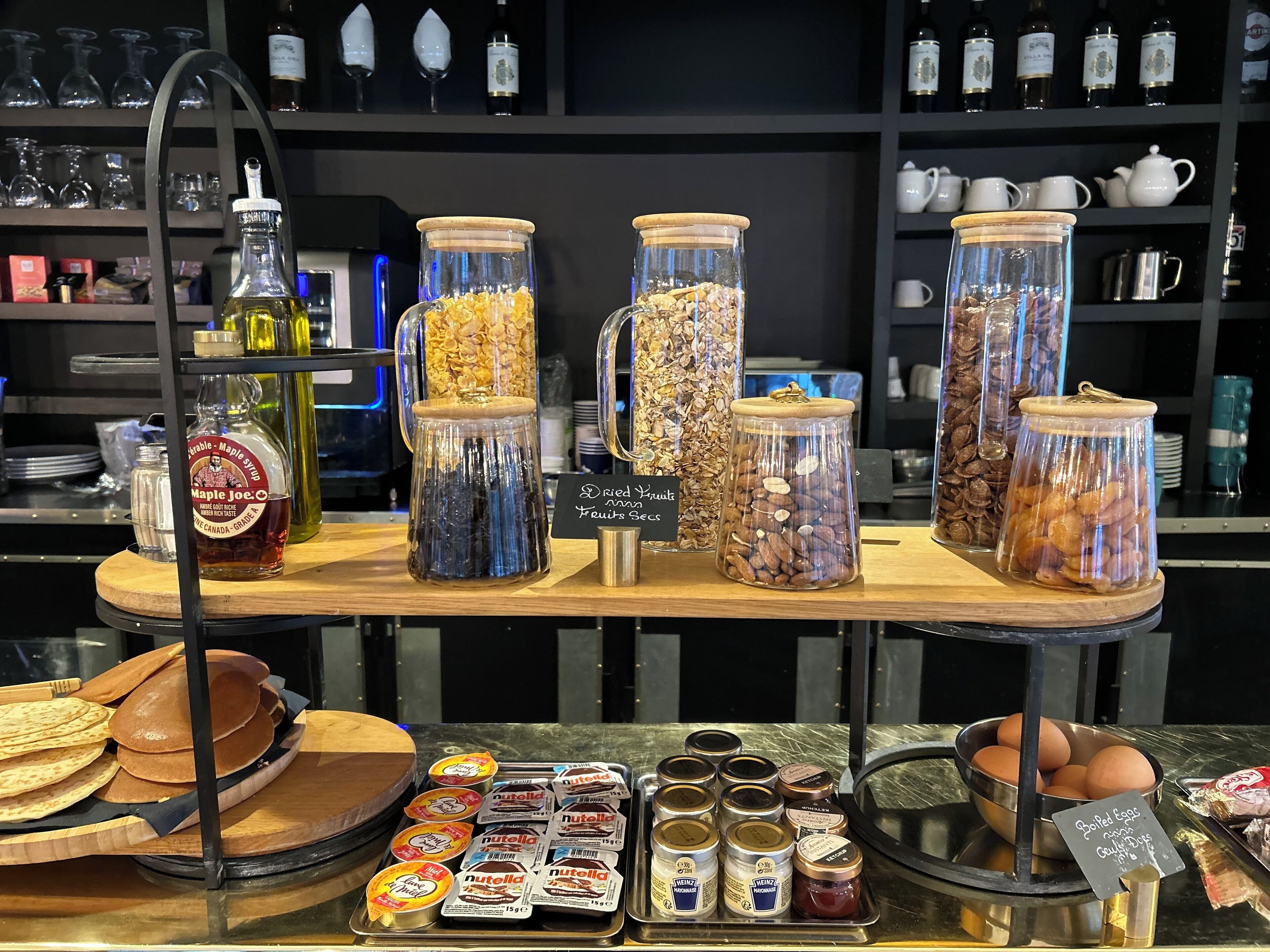 A display of food items including dried fruits, nuts, and condiments.
