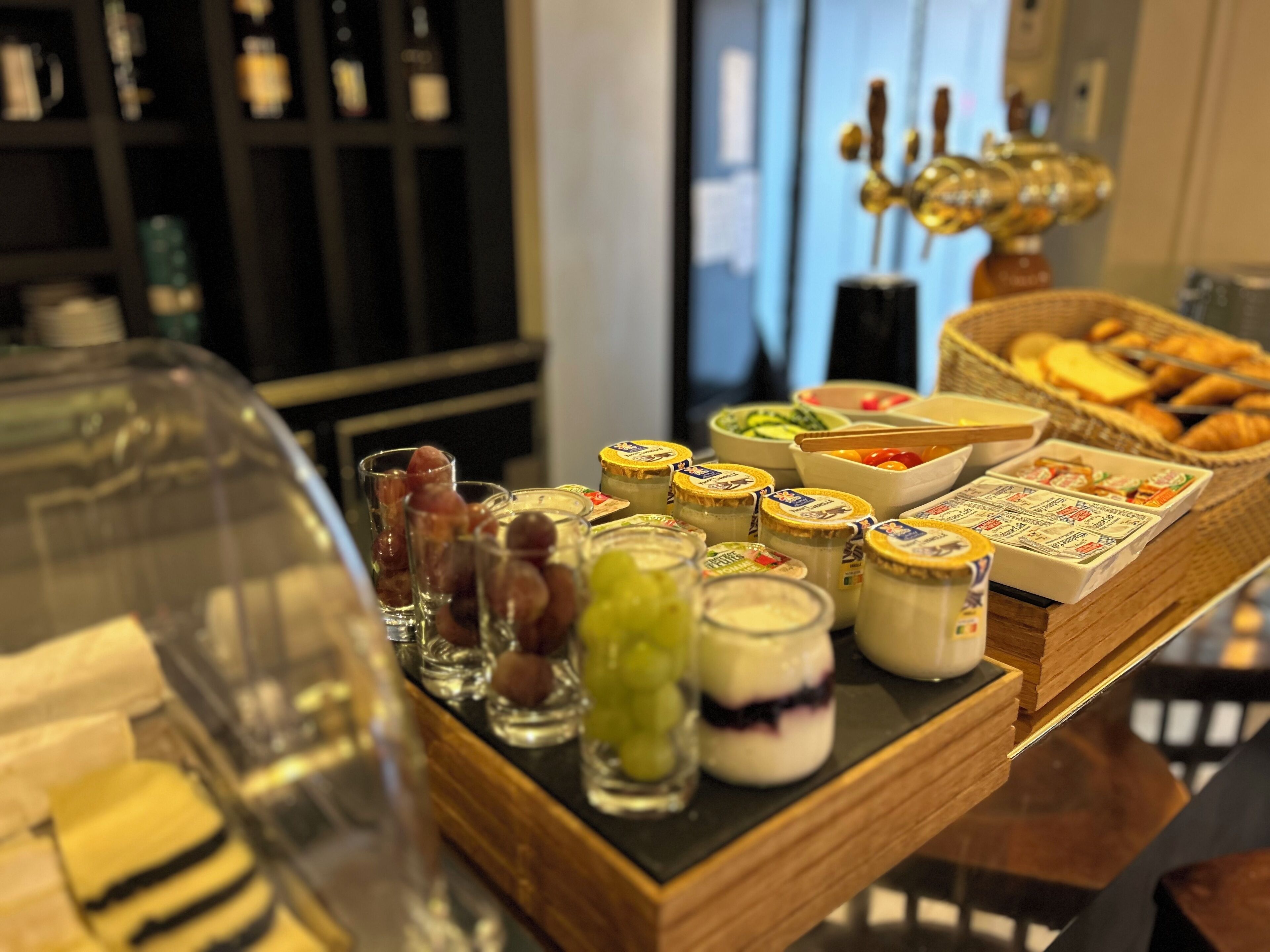 A buffet table with various food items and condiments.