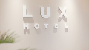 A wall with the words "LUX HOTEL" in white letters. - Hotel Lux (Düsseldorf)