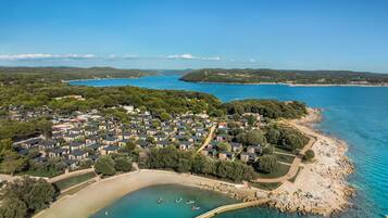 On the beach, sun loungers, beach umbrellas, rowing