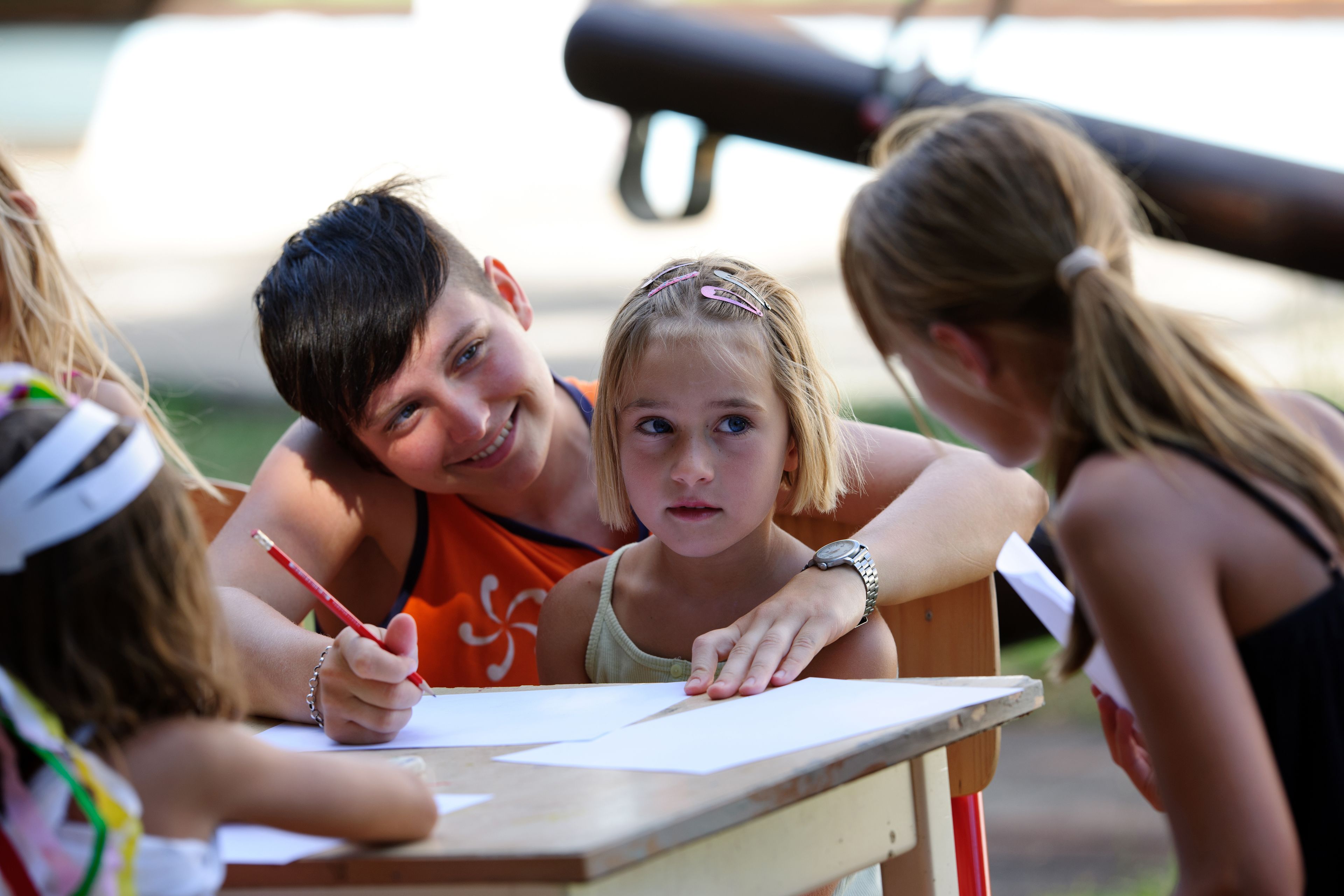 A group of people gathered around a table, engaged in an activity.