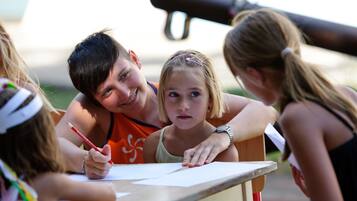 A group of people gathered around a table, engaged in an activity.