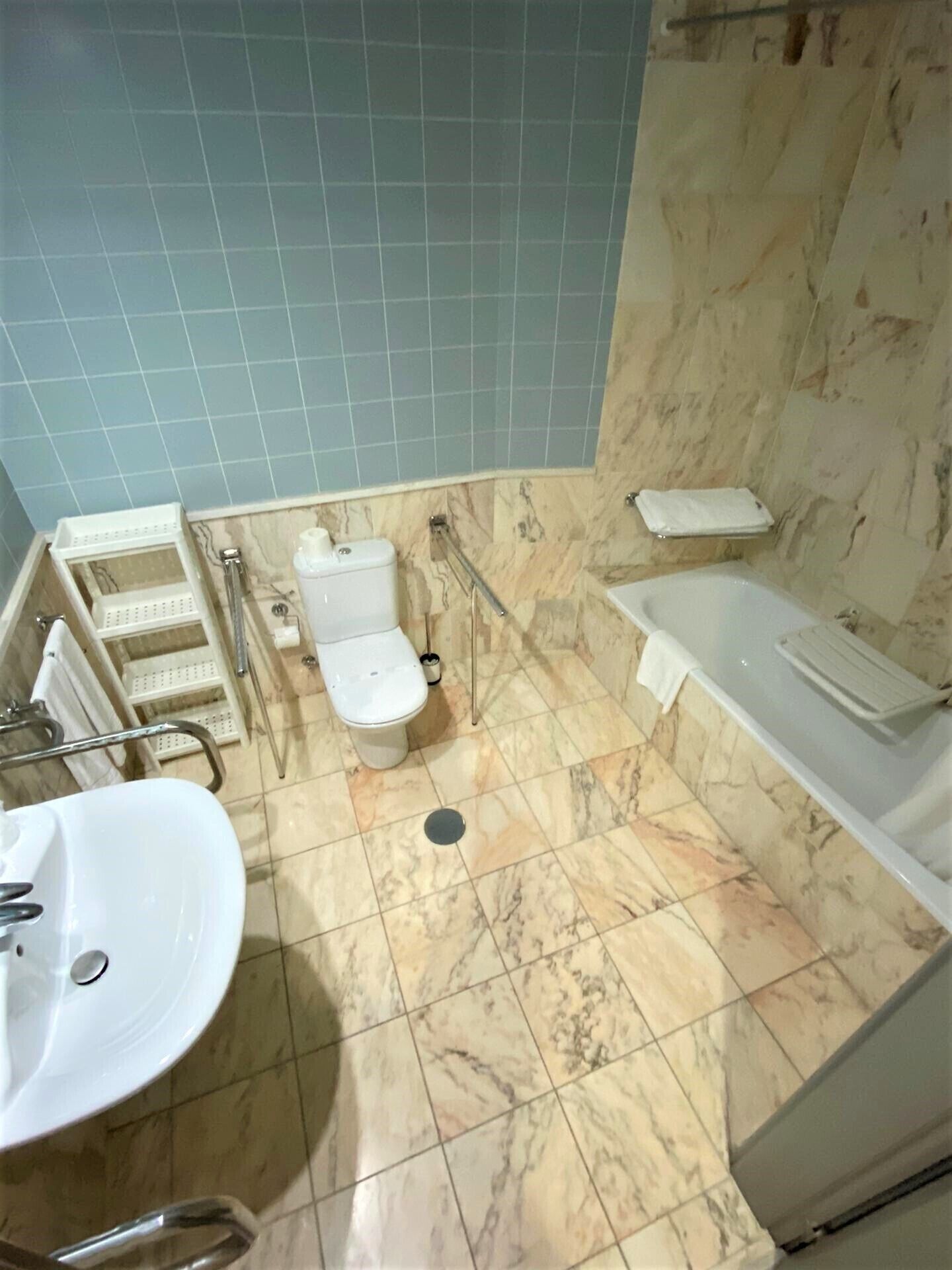 A bathroom with a toilet, sink, and bathtub.