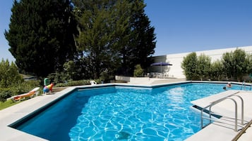 Outdoor pool, open 10:00 AM to 7:00 PM, pool loungers