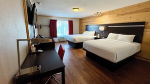 A hotel room with two beds, a desk, a chair, a TV, and a window with curtains. - Americas Best Value Inn Wall (Wall)