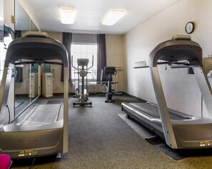 A gym with treadmills, an elliptical, and a stationary bike. - Comfort Inn & Suites Madison North (De Forest)