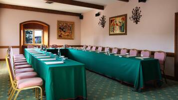 A conference room with a long table, chairs, and a large window.