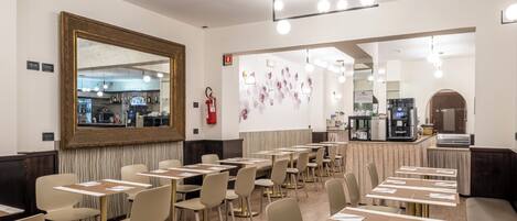 A restaurant with tables and chairs arranged for dining.