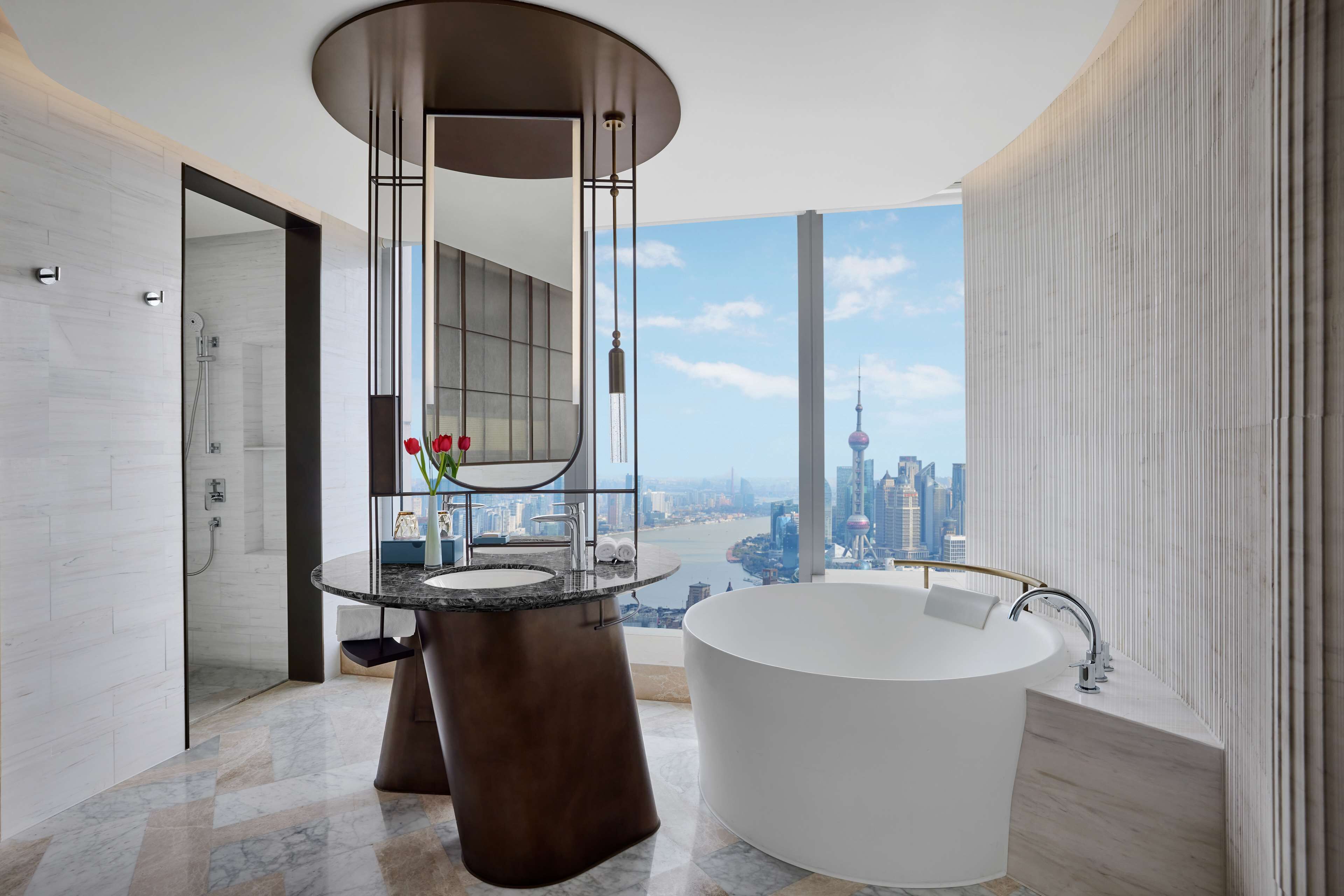 premium bund view suite | bathroom | separate bathtub and shower, rainfall showerhead, designer toiletries