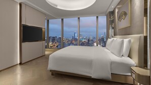 A modern hotel room with a large bed, a flat-screen TV, and a city view. - Conrad Shanghai (Shanghai)
