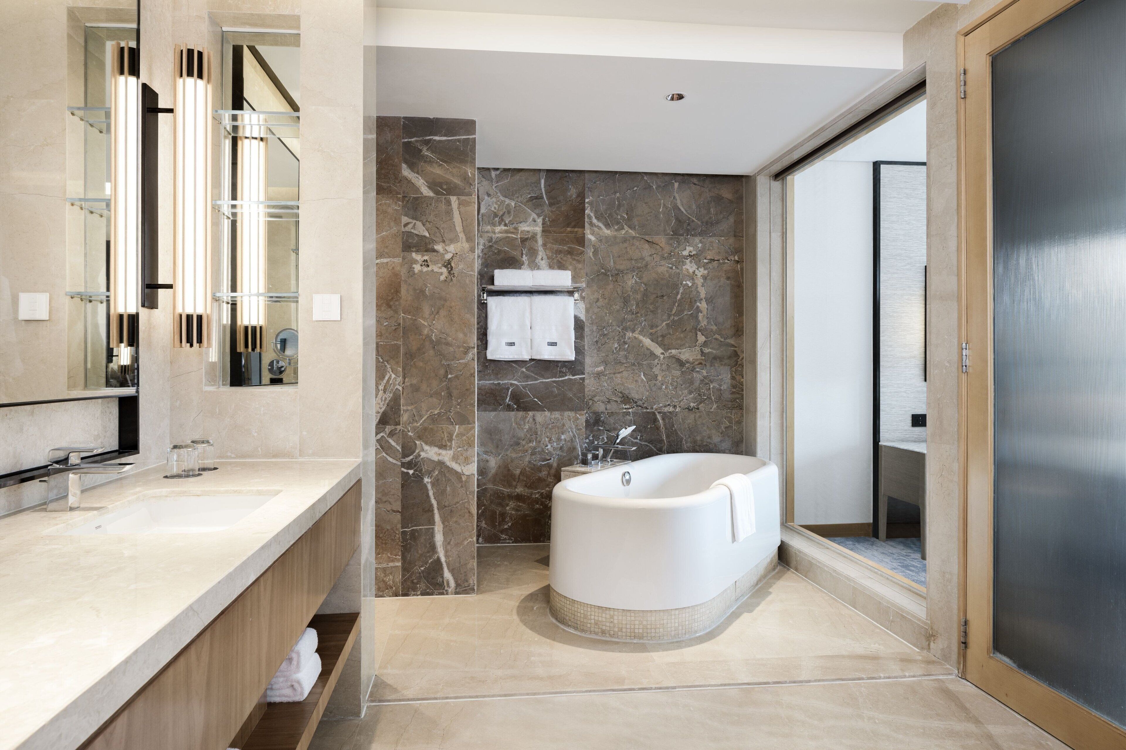 separate bathtub and shower, rainfall showerhead, designer toiletries