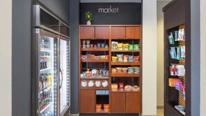 A grocery store interior with refrigerated beverages, snack aisles, and a visible 'market' sign. - Courtyard by Marriott Hanover Lebanon (Lebanon)