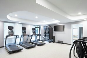 A fitness room with treadmills, exercise balls, and a TV. - Courtyard by Marriott Hanover Lebanon (Lebanon)