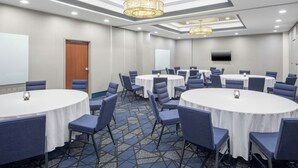 A conference room with round tables, chairs, and a large screen. - Courtyard by Marriott Hanover Lebanon (Lebanon)