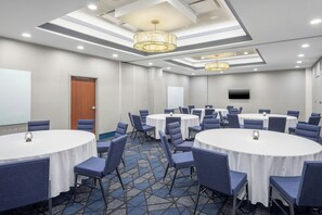 A conference room with round tables, chairs, and a large screen. - Courtyard by Marriott Hanover Lebanon (Lebanon)