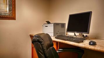 A desk with a computer, keyboard, and mouse.