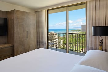 Hotel amenities such as safe, desk and work area at Embassy Suites by Hilton Waikiki Beach Walk