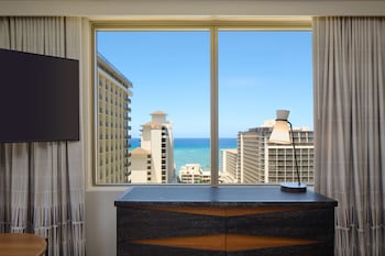Hotel amenities such as safe, desk and work area at Embassy Suites by Hilton Waikiki Beach Walk