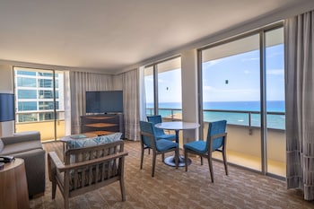 Premium Suite, 1 Bedroom, Ocean View, Corner (Balcony) | Living area | 55-inch flat-screen TV with cable channels, TV, iPod dock at Embassy Suites by Hilton Waikiki Beach Walk