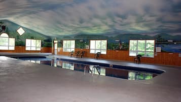 Relax by the pool surrounded by a scenic mural and comfortable seating.