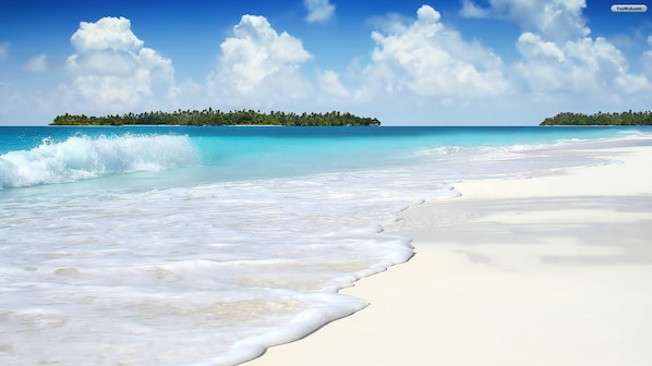 A beach with clear turquoise water, white sand, and a small island with trees in the background. - Holiday Inn Express Hotel & Suites West I 10 by IHG (Pensacola)