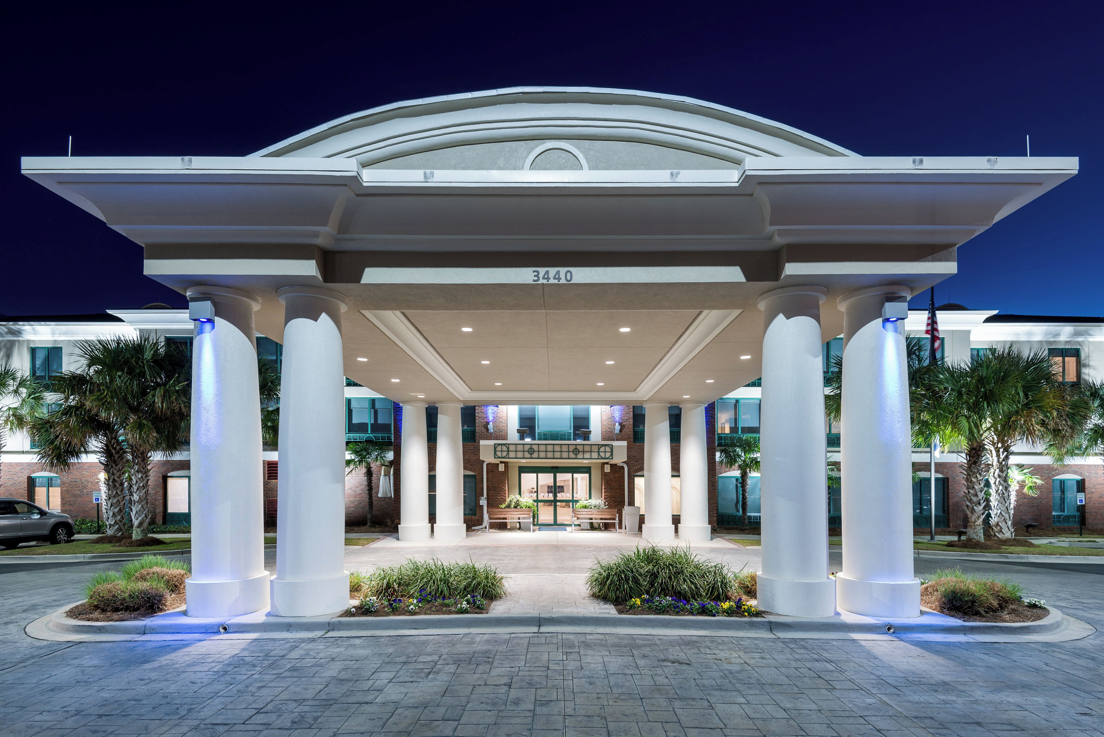 A hotel entrance with a covered walkway, columns, and a number '340' sign.