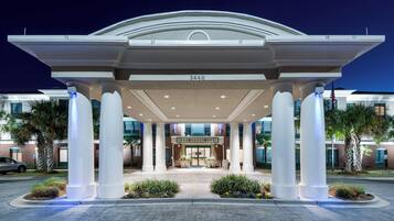 A hotel entrance with a covered walkway, columns, and a number '340' sign.
