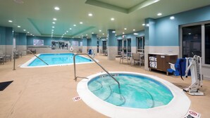 A hotel pool area with two pools, a lifeguard stand, and a towel service station. - Holiday Inn Express & Suites Florence I-95 & I-20 Civic Ctr by IHG (Florence)