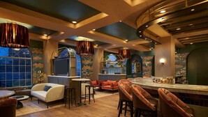 A cozy bar area with wooden flooring, cushioned seating, and pendant lighting. - Hotel Vesper, Houston, a Tribute Portfolio Hotel (Houston)