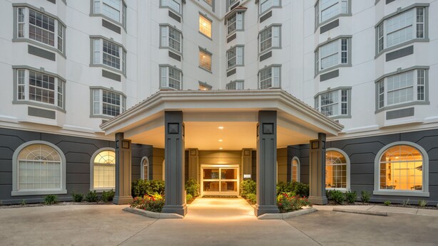 A multi-story hotel with a central entrance, large windows, and a symmetrical facade. - Hotel Vesper, Houston, a Tribute Portfolio Hotel (Houston)