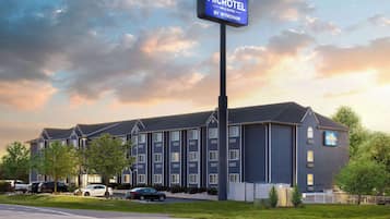 Guests can enjoy a modern hotel with a flat roof and linear windows, situated in a well-maintained area with parking available.