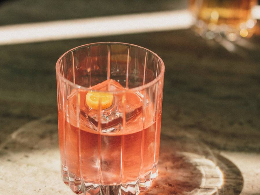 Un vaso con una bebida sobre una superficie de mármol.