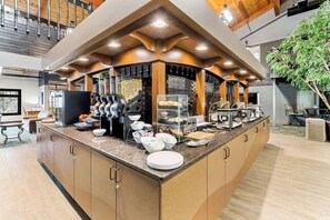 A modern kitchen with a central island, built-in appliances, and a variety of utensils and cookware.
