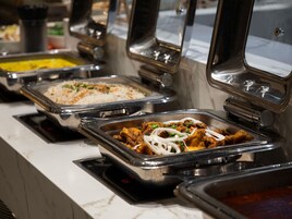 A buffet with various dishes including rice, meat, and vegetables.