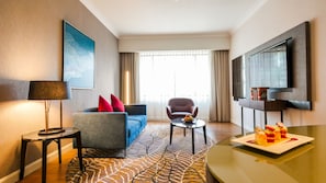 Junior Suite, 1 King Bed | Living area | 55-inch TV with satellite channels