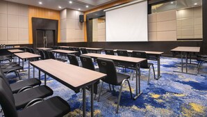 A conference room with tables, chairs, a projector screen, and a large screen. - Novotel Kuala Lumpur City Centre (Kuala Lumpur)
