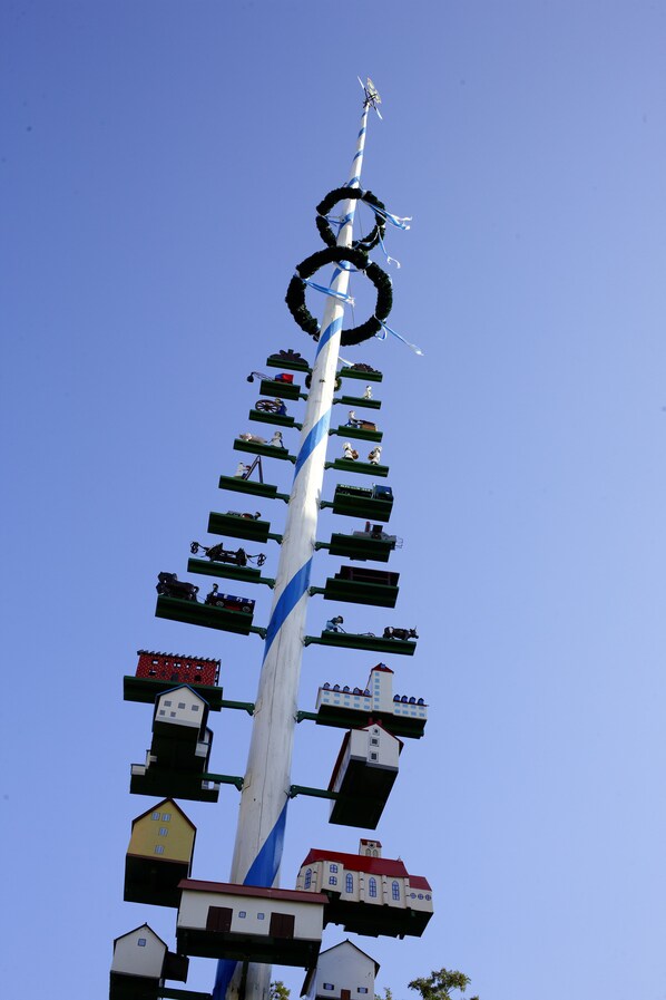 A tall structure with multiple levels, each featuring different architectural styles and designs. - Hotel Gruenwald (Munich)