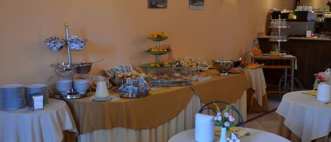 Un buffet garni de divers plats, avec une cuisine en arrière-plan.