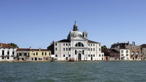A historic building with a prominent dome and bell tower, situated by a waterfront. - Bauer Palladio Hotel & Spa (Venice)