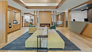 A modern lobby with a reception desk, seating area, and a fireplace. - Fairfield Inn and Suites by Marriott Sacramento Elk Grove (Elk Grove)