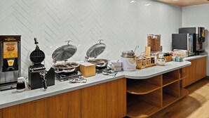 A modern kitchen with a waffle maker, coffee machine, and various food dispensers. - Fairfield Inn and Suites by Marriott Sacramento Elk Grove (Elk Grove)