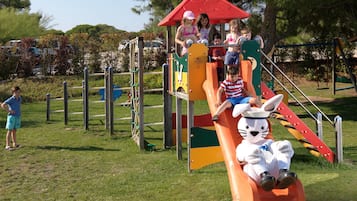 Kids can play and climb in this secure outdoor play area with a slide and climbing structures.