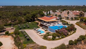 An aerial view of a resort with a swimming pool, sun loungers, and a landscaped garden. - Vila Alba Resort (Lagoa)